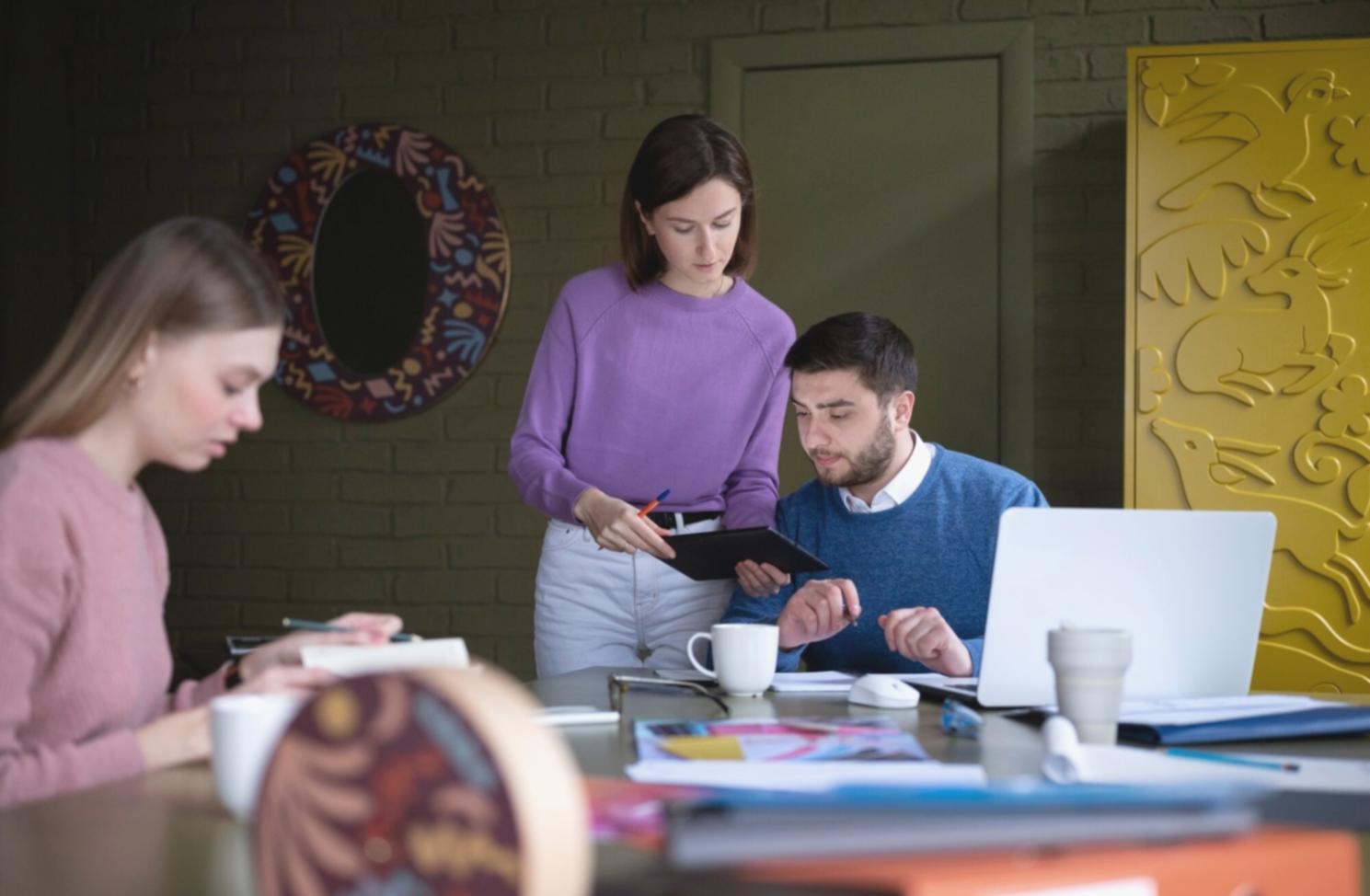 Financial planning discussion with charts and documents on a desk